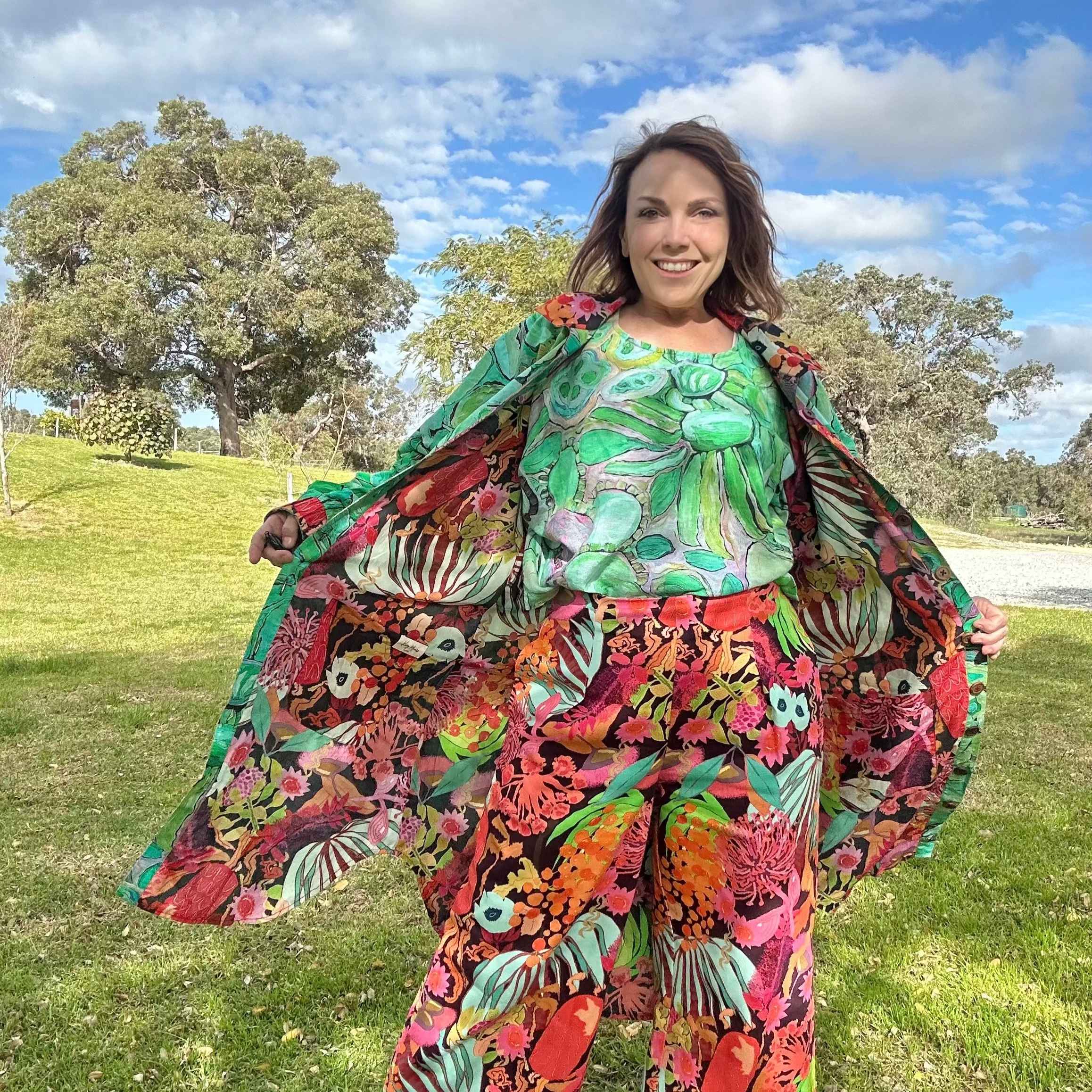 Woman in a colourful cotton wearable art reversible coat dress