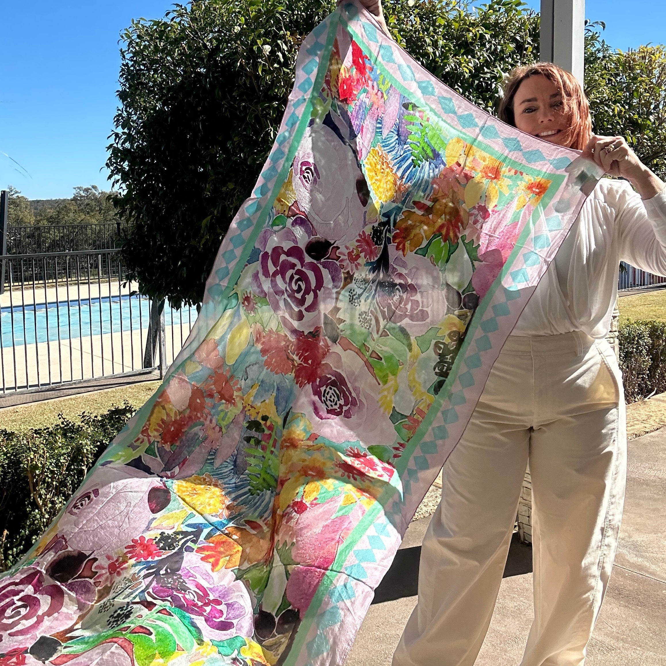 Oversized wearable art silk scarf featuring soft floral coral artwork in pastel tones by Australian artist Kerry Munns