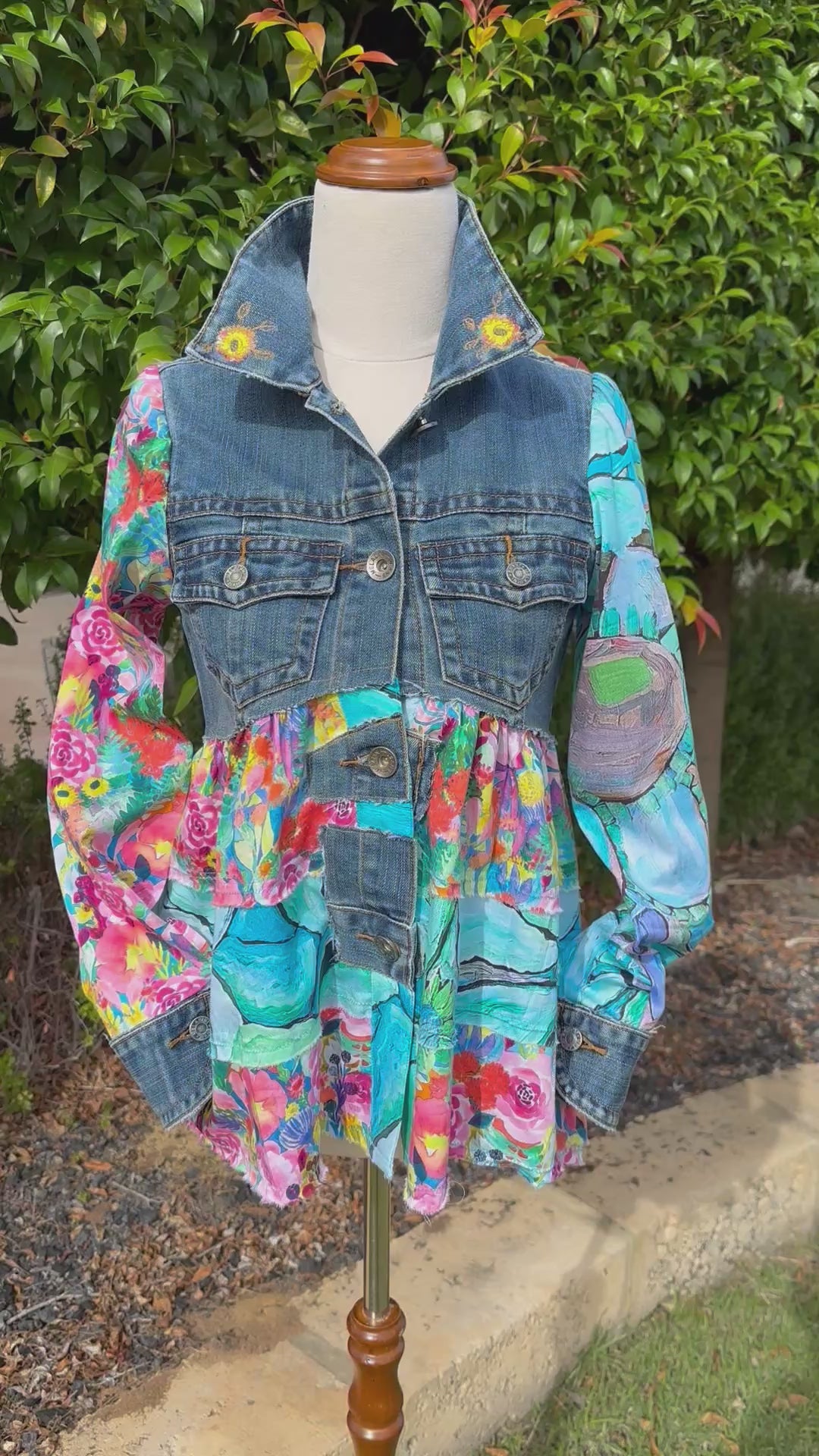 Bold recycled denim jacket transformed into vibrant wearable art, part of sustainable women's fashion. Video