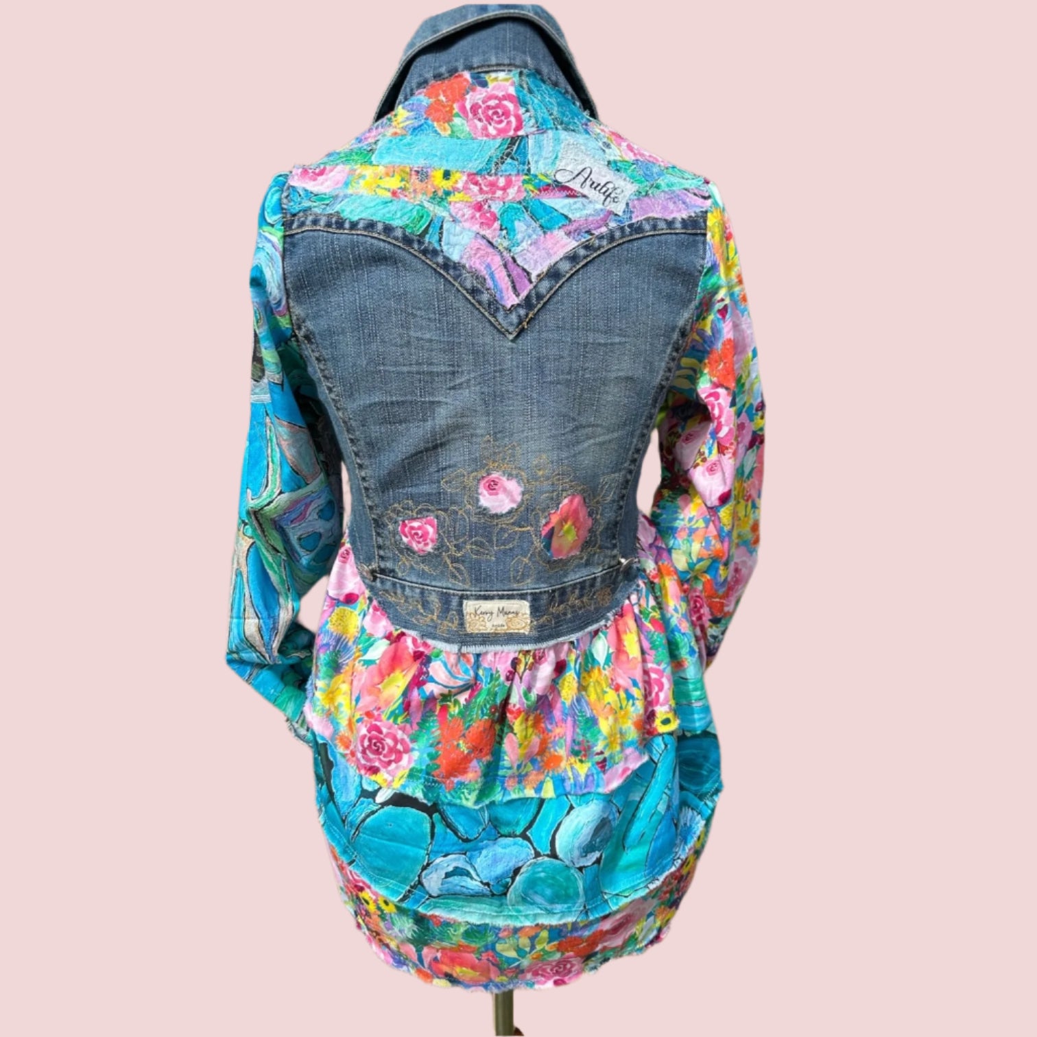 Bold recycled denim jacket transformed into vibrant wearable art, part of sustainable women's fashion 1