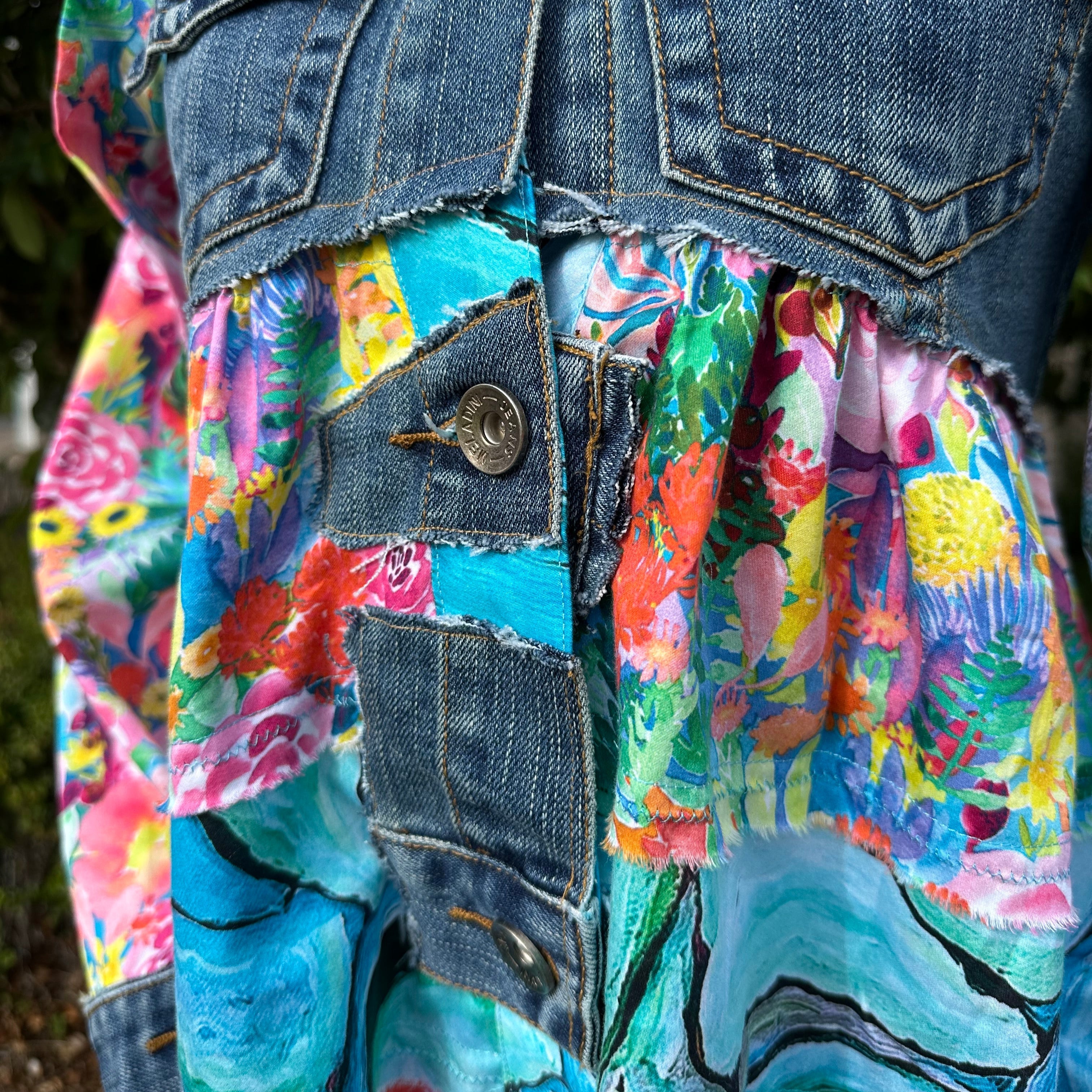 Bold recycled denim jacket transformed into vibrant wearable art, part of sustainable women's fashion.front details