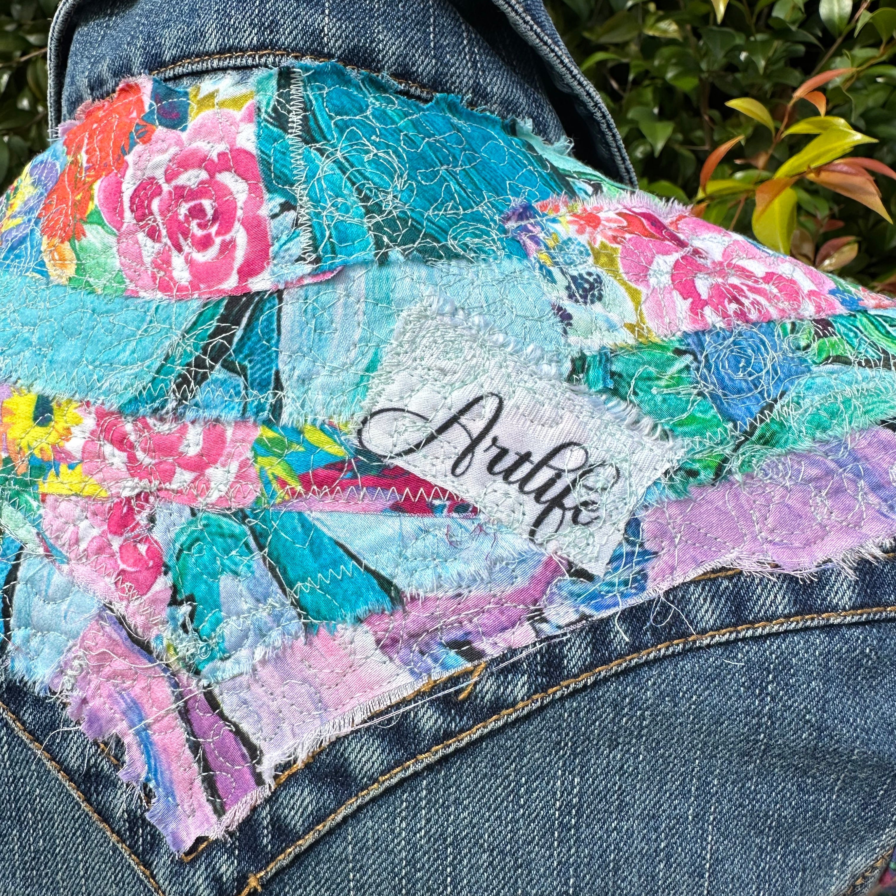 Bold recycled denim jacket transformed into vibrant wearable art, part of sustainable women's fashion.5