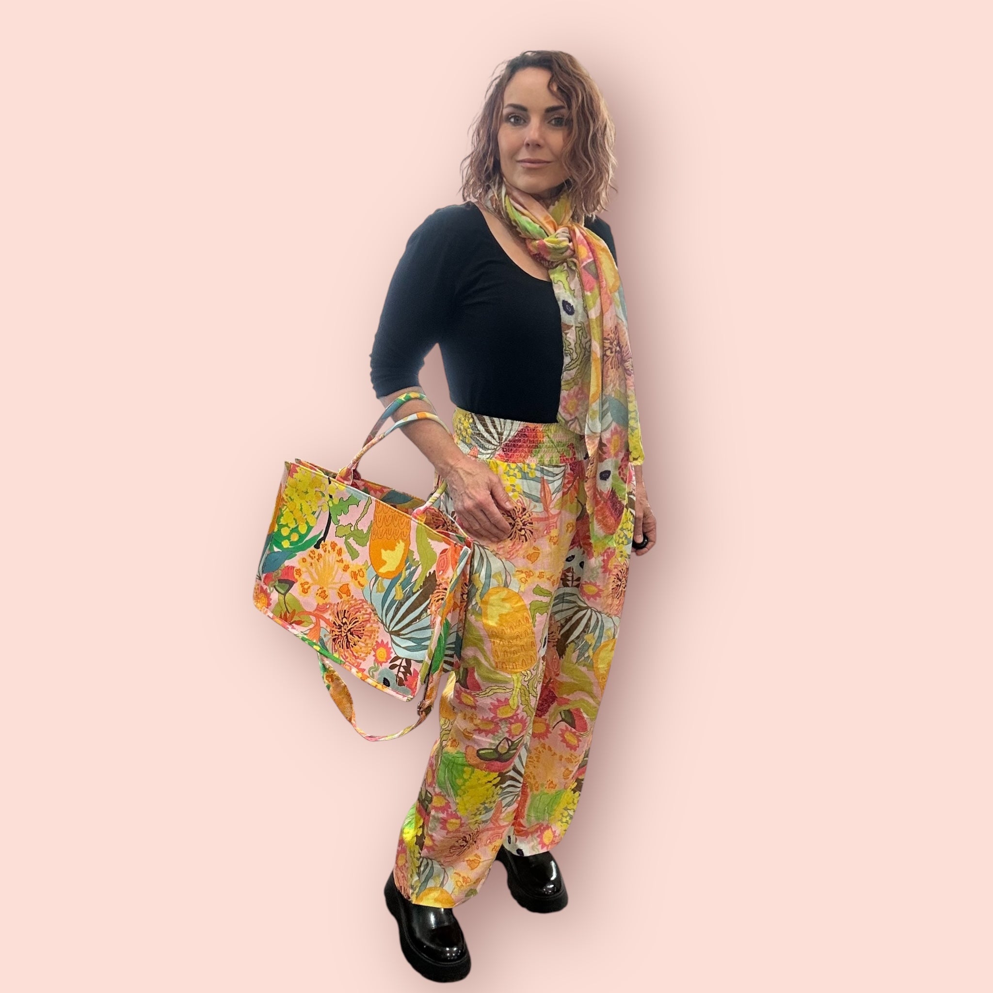 Linen pants featuring pastel brushstroke wearable art, a breezy and artistic piece of women’s fashion, side front view