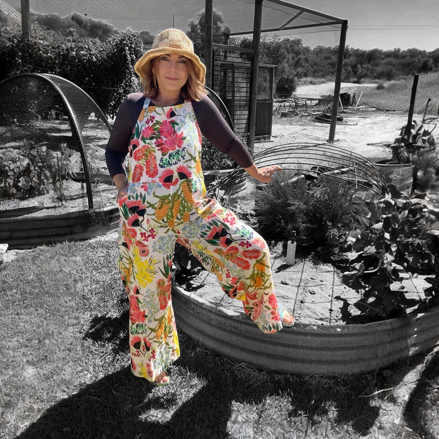 Zoe Playsuit in Spring Fling by Kerry Munns Artlife showcasing vibrant wearable art on sustainable linen fabric model resting leg