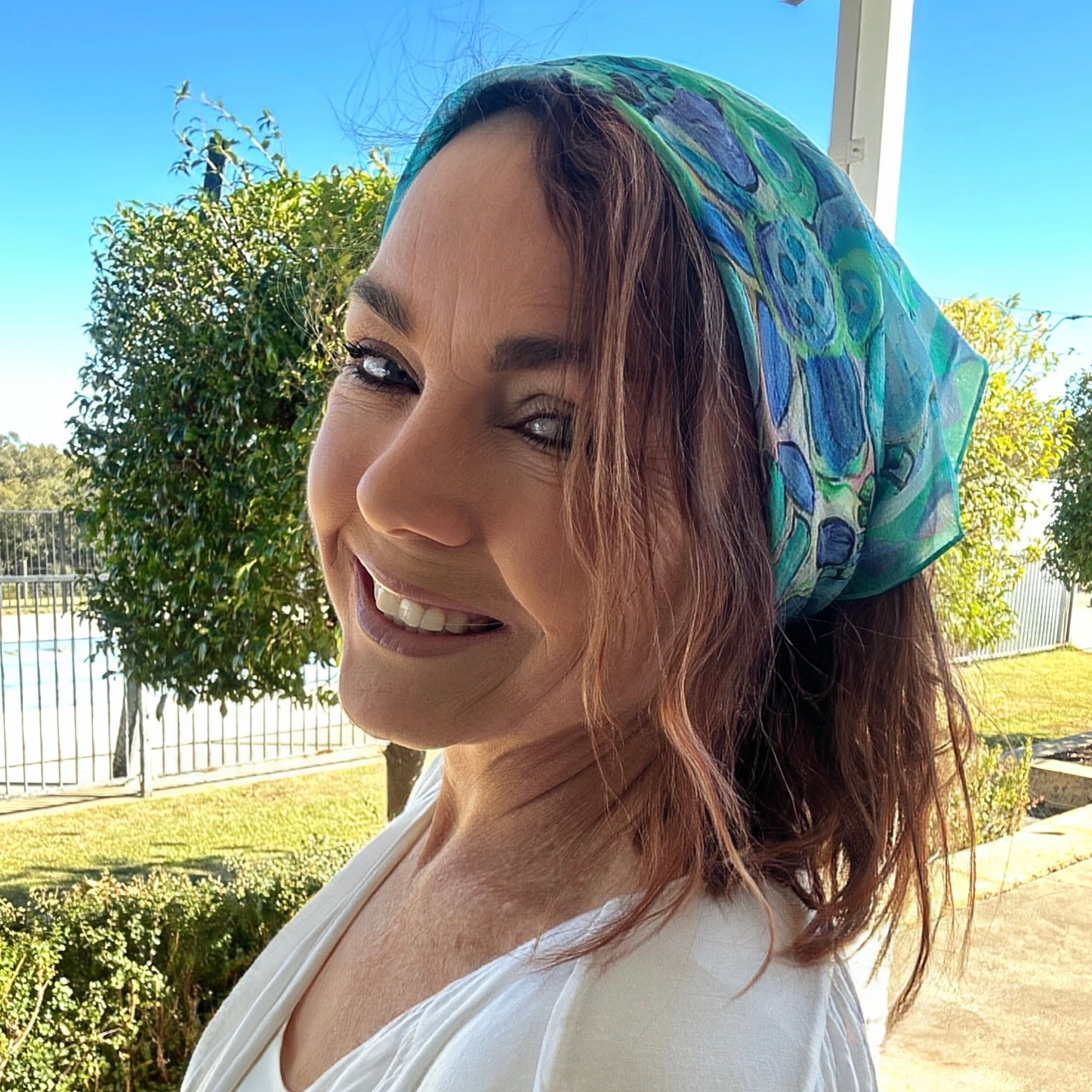 Blue and green wearable art bandanna featuring original abstract artwork by Kerry Munns styled as a soft bohemian headscarf