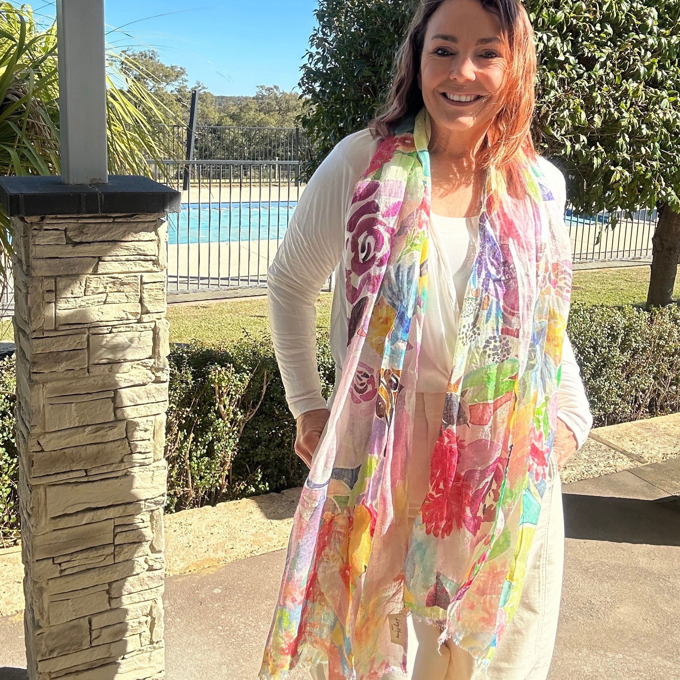 Colourful wearable art linen scarf featuring vibrant floral watercolour artwork by Australian artist Kerry Munns.