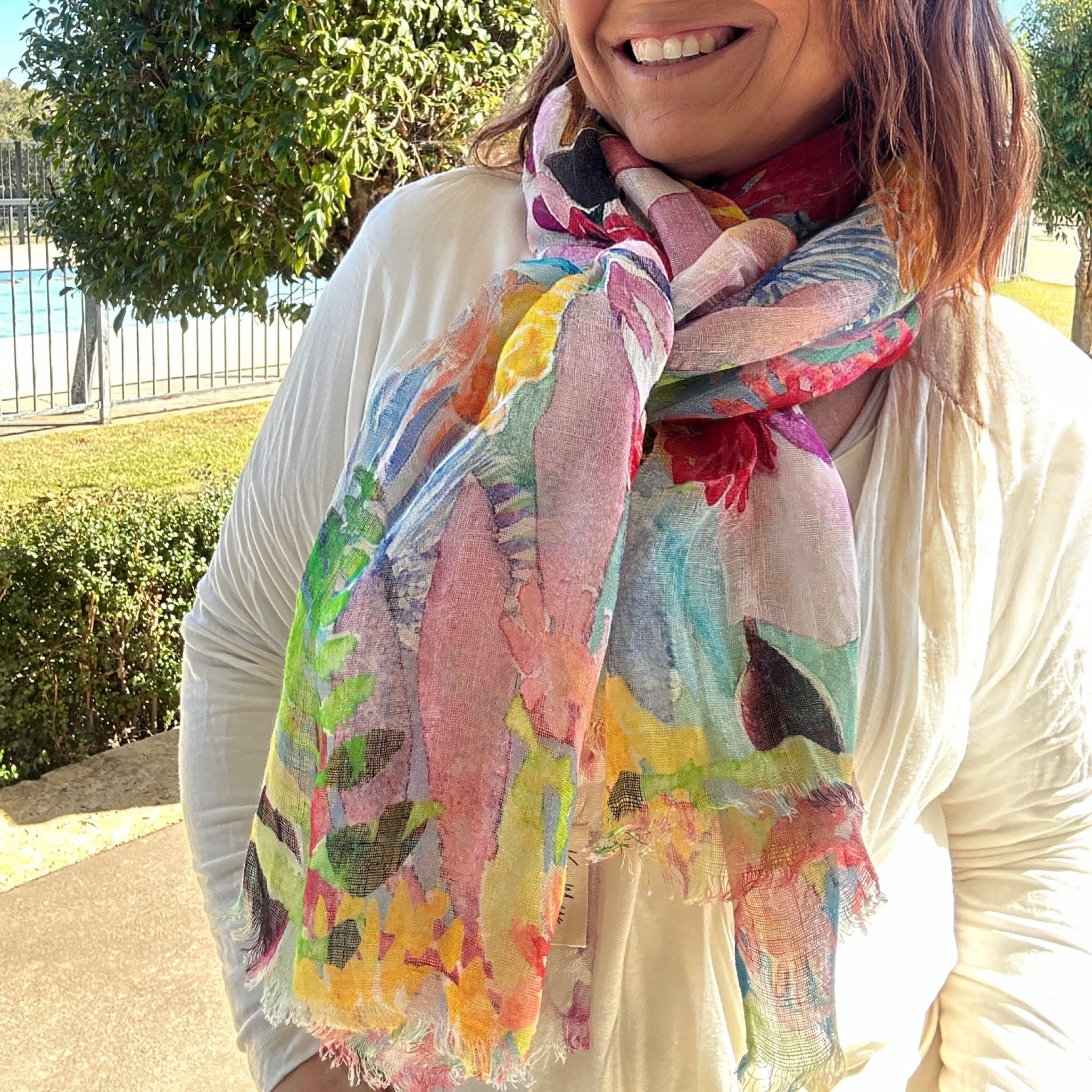Colourful wearable art linen scarf featuring vibrant floral artwork by Australian artist Kerry Munns