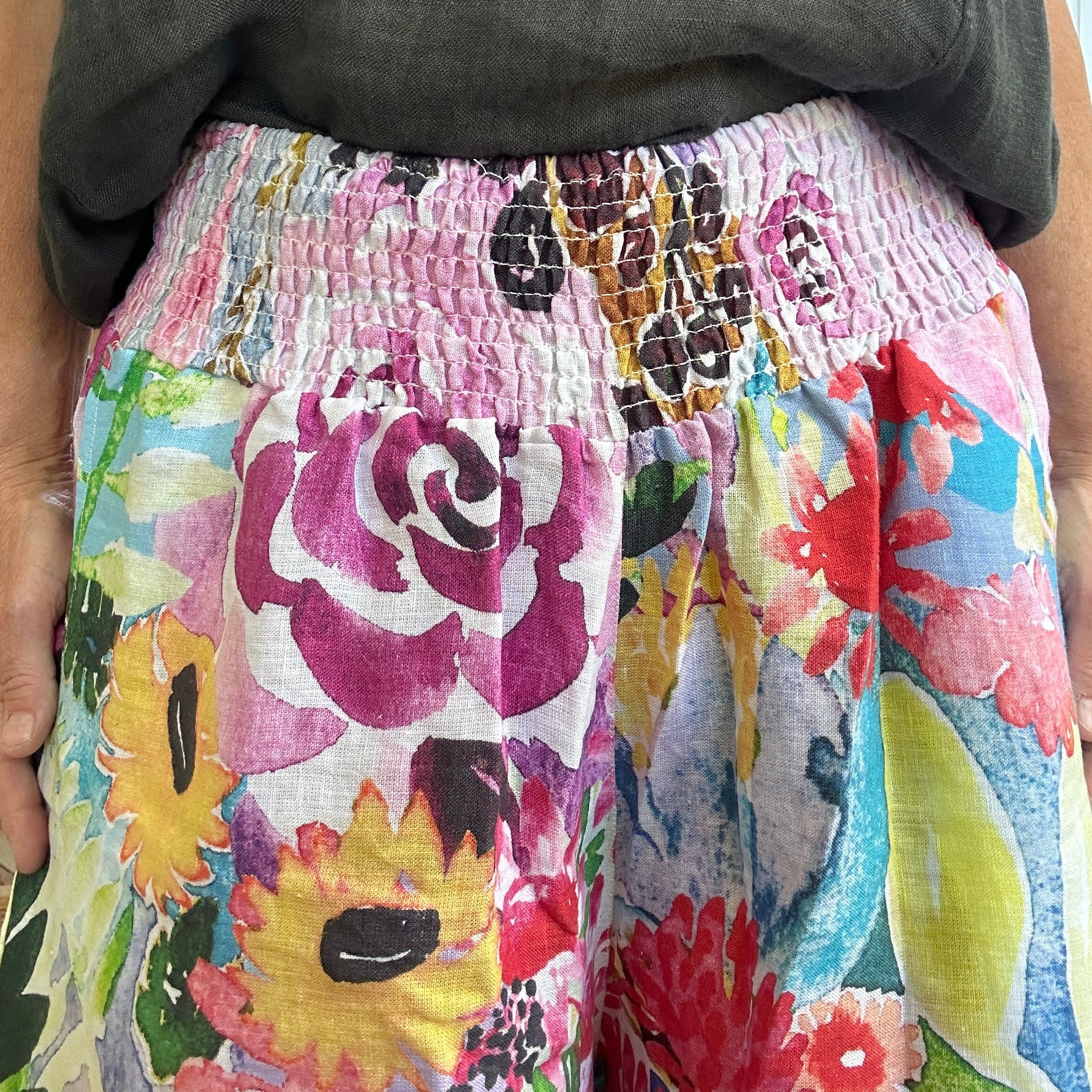 Close view of wearable art Culotte linen pants by Kerry Munns featuring watercolour floral artwork, extra wide leg full length womens linen pants with elastic waist and side pockets
