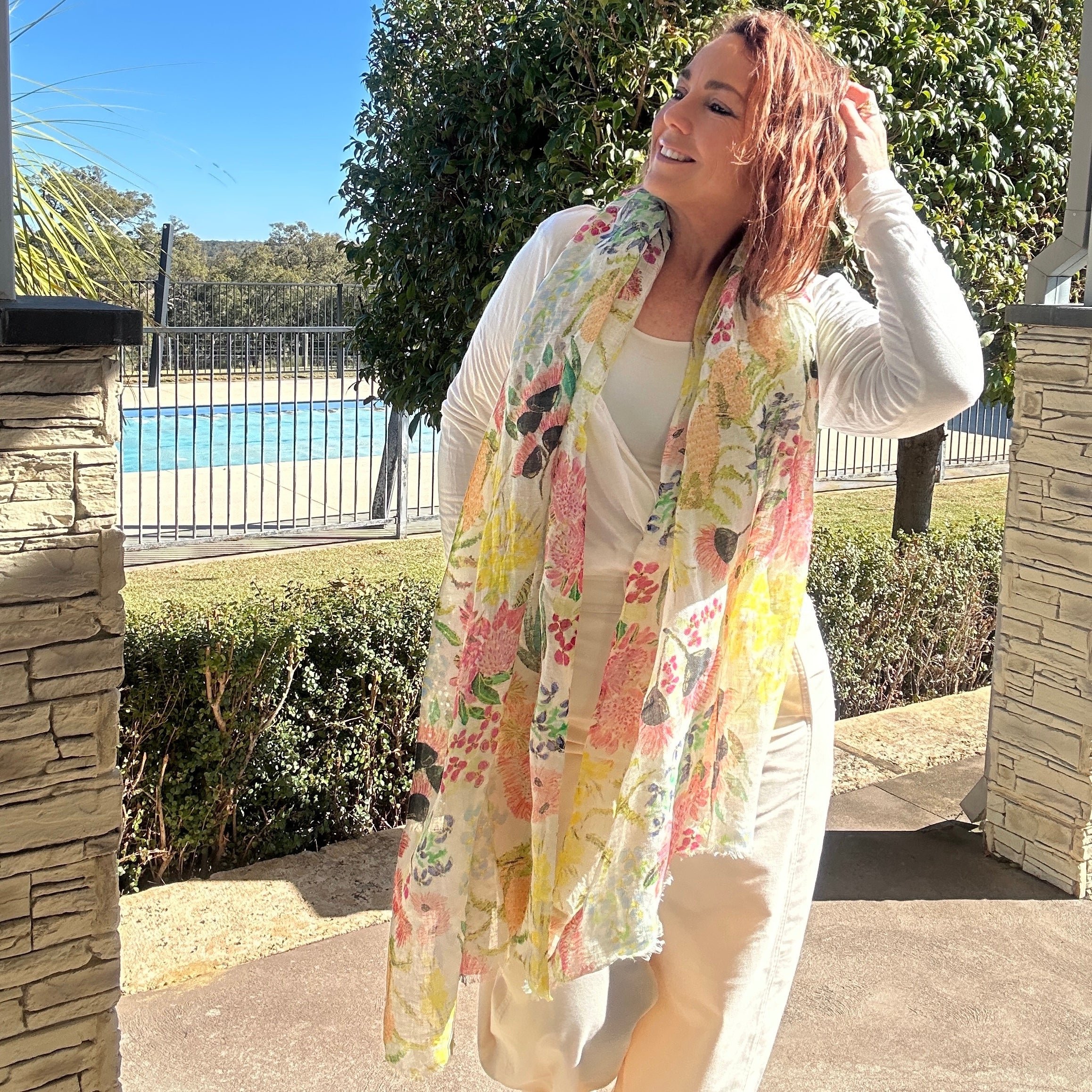 Lightweight wearable art linen scarf featuring soft Australian wildflowers -inspired artwork in pastel tones