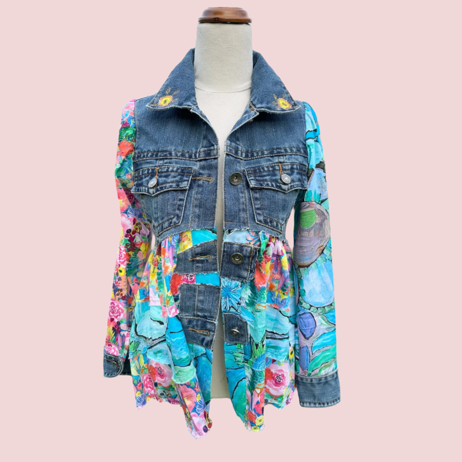 Bold recycled denim jacket transformed into vibrant wearable art, part of sustainable women's fashion.