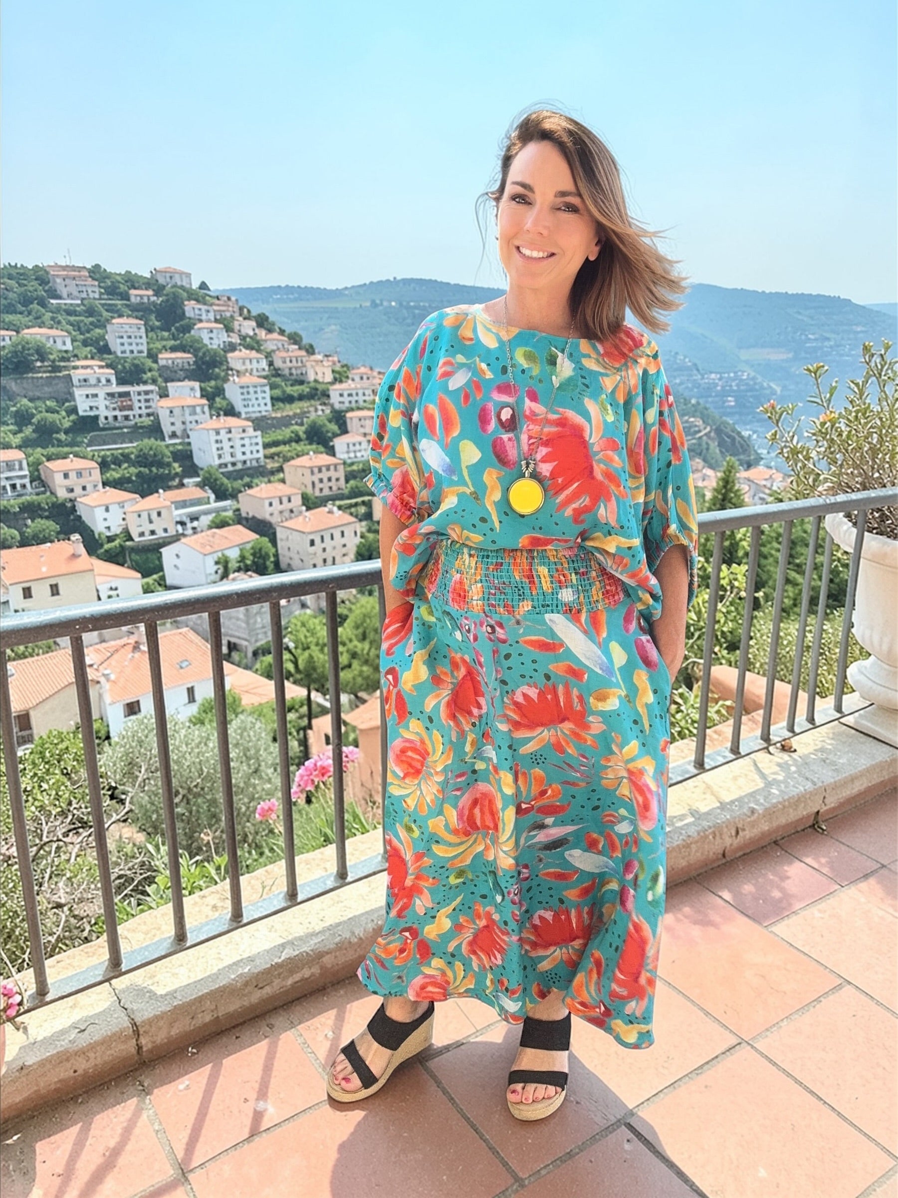 Turquoise wearable art linen skirt with vibrant wildflower print, full length women’s floral fashion