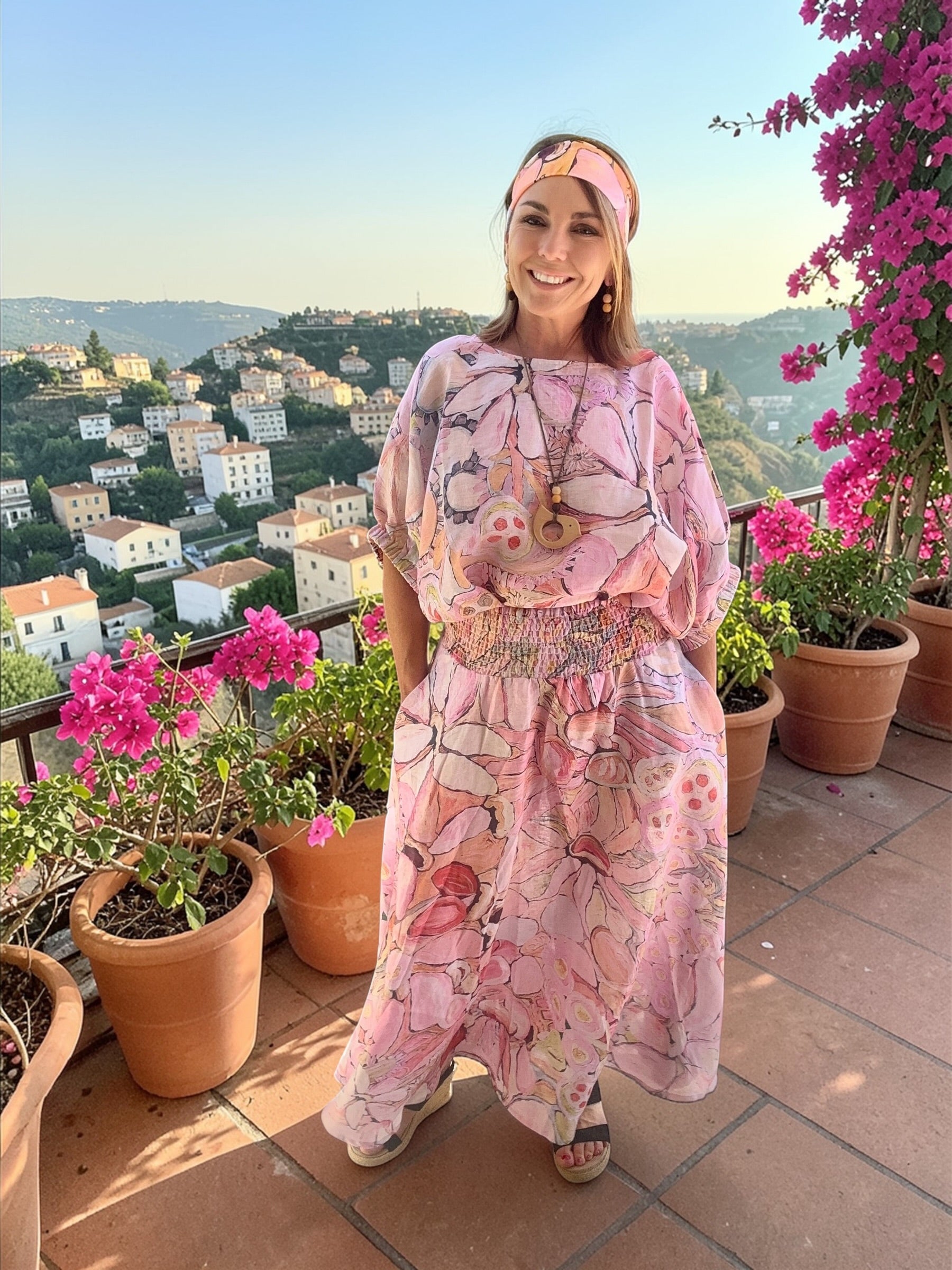 Blush pink wearable art linen skirt with painterly floral print, full length women’s fashion with elastic waistband